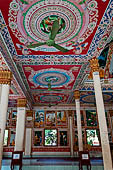 Vientiane, Laos - Pha That Luang, among the Other structures on the ground there is an open sala decorated with brightly colored paintings. 